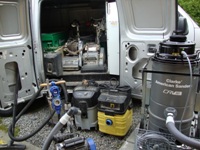 The truck full of floor sanding machines and sanders for refinishing floors of hardwood on a gymnasium